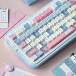 Distinctive Cowboy Sweetheart PBT Cherry profile keycaps, showing their playful blue and pink western-themed design from a side view.