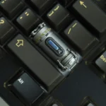 A detailed view of the handcrafted Enriched Uranium Sample resin keycap, showcasing its unique post-apocalyptic glow and rugged tactical design from various angles.