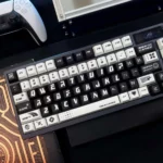 An artistic product gallery displaying the unique Dreamcore PBT dye-sublimated keycap set, highlighting its monochromatic surrealism.