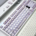 A beautifully arranged Vintage Rose PBT keycap set showcasing soft hues and subtle side-printed legends in an artistic composition.