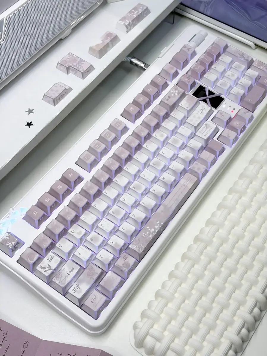 A beautifully arranged Vintage Rose PBT keycap set showcasing soft hues and subtle side-printed legends in an artistic composition.