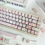A collection of Gentle Landing MOA PBT keycaps showcasing their serene glazed aesthetic and unique profile from various angles.