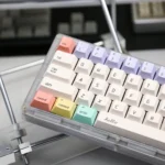 Durable 'Hello World' PBT dye-sub keycaps, Minty Fresh Set, shown at a playful angle. Features a crisp, nostalgic retro-tech design.