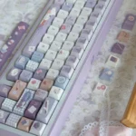 Charming Little Tailor Artistry PBT Tailor Keycap Set, detailed from a fresh angle, highlighting the meticulous motif and durable texture.