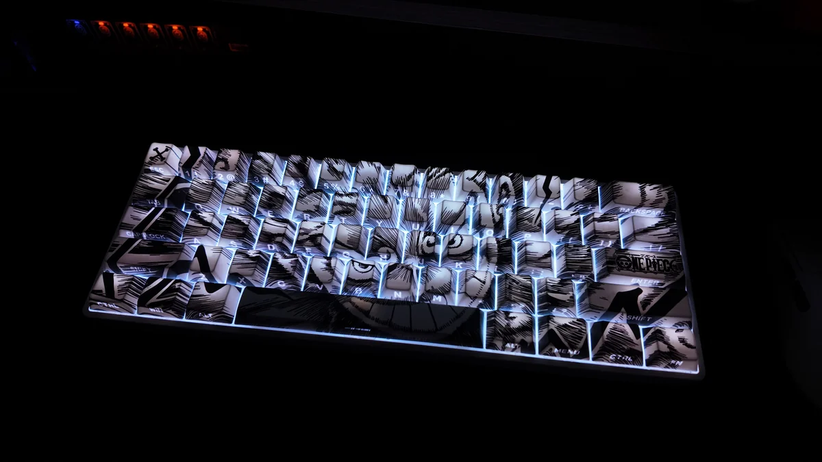 Dynamic shots of the premium One Piece Luffy PBT backlit keycap set, featuring its unique side-engraved legends and vibrant, light-transmitting design.