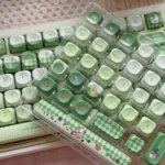 Whimsical Matcha Totoro PBT keycaps for keyboards, shown from multiple playful angles, highlighting calming matcha green and charming Totoro designs.