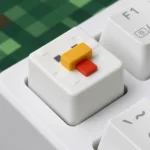 A close-up of a charming handcrafted Minecraft animal keycap, a vibrant resin pixel pal, showcasing its blocky details from a unique angle.