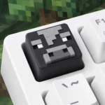 Vibrant handcrafted Minecraft pig animal resin keycap, playfully detailed from a unique side angle, showcasing its pixelated charm.