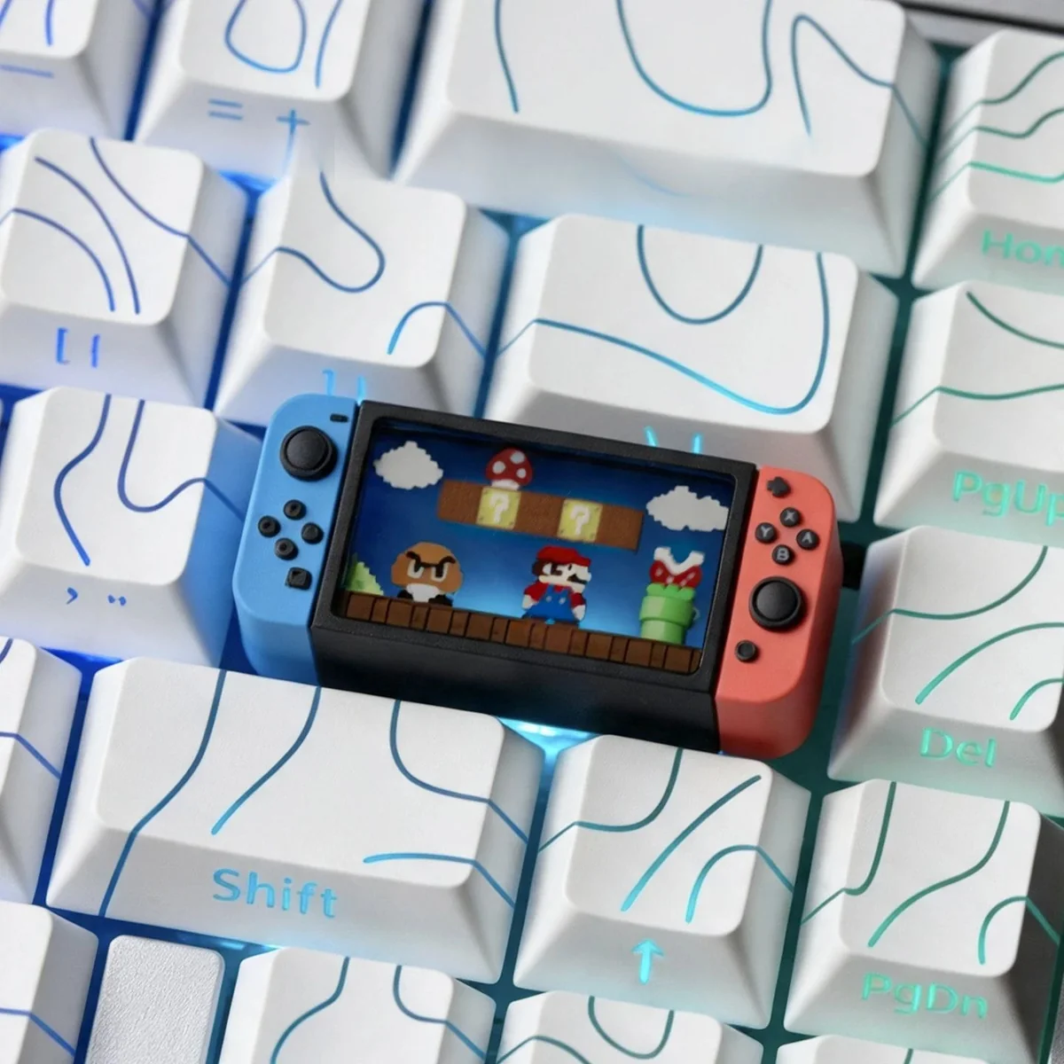 Close-up gallery views of a playful, translucent Nintendo Switch Series Super Mario keycap, showcasing its intricate miniature console design from various angles.