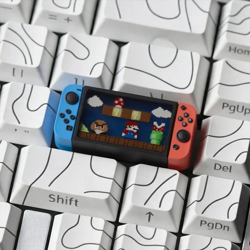 Iconic Nintendo Switch Series Super Mario keycap gallery, showing its playful miniature console design from different angles with translucent details for gaming keyboard.
