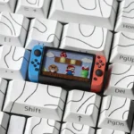 Close-up of the iconic Nintendo Switch Series Super Mario keycap from multiple angles, highlighting its miniature console design and playful details for gaming keyboard.