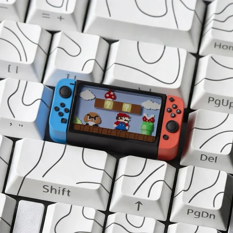 Close-up of the iconic Nintendo Switch Series Super Mario keycap from multiple angles, highlighting its miniature console design and playful details for gaming keyboard.