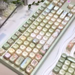 Meadow Ode Luminous Side-Lit PBT Keycap Set. Multiple angles highlight nature-inspired designs, soft side-lit glow, and refined PBT texture.