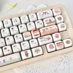Close-up views of adorable pink bear MOA profile keycaps set, highlighting their unique smooth jade-like texture and charming design from multiple angles.