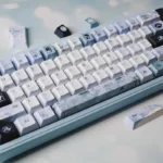 Handcrafted Plum Blossom Frost PBT keycaps, captured from a unique angle, reveal serene traditional Chinese artistry and frosty details on an elegant dark.