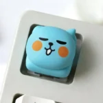 Multiple views of a Qoo Expression Keycaps, highlighting its expressive cartoon character design and vibrant colors, ideal for a whimsical ESC key.