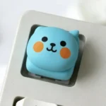 Qoo Expression Keycaps gallery showing playful character and expressive ESC keycaps from various angles. Vibrant, adorable designs for keyboard personalization.
