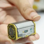 Detailed view of the handcrafted Radioactive Scrap Box keycap, showcasing its gritty post-apocalyptic resin barrel design from a unique angle.