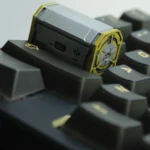 Close-up of a handcrafted Radioactive Scrap Box barrel keycap, showcasing its gritty post-apocalyptic resin details and vibrant yellow-green hues from a unique angles.