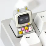 A close-up view of a Retro Desktop Computer Artisan Keycaps, showcasing its intricate miniature desktop computer design and glowing backlight design.