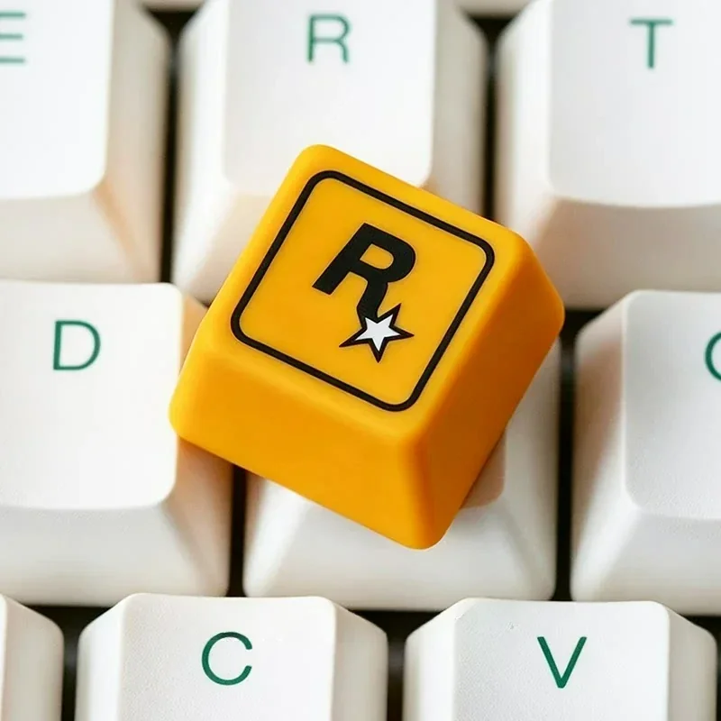 Close-up of the iconic Rockstar Games resin ESC keycap, showcasing the bold R* logo and sleek finish from a dynamic new angle, perfect for a custom gaming keycap.
