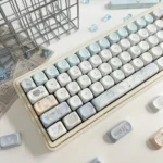 Close-up of Sacred Feather Prayer MOA Keycap Set, highlighting ethereal feather motifs and soft celestial accents. A peaceful, artistic keyboard aesthetic.