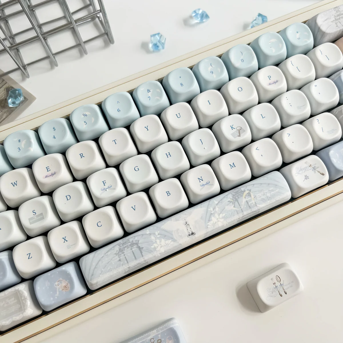 Close-up of the Sacred Feather Prayer MOA Keycap Set, showcasing delicate feather motifs and soft, celestial colors from various angles, creating an ethereal design.
