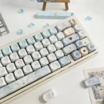 Sacred Feather Prayer MOA Keycap Set: Ethereal MOA dye-sub set, featuring delicate feather motifs and soft celestial accents. Inspires a peaceful, artistic keyboard.