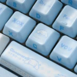 Lustrous premium ceramic Cinnamoroll keycaps, displaying their whimsical side-engraved art and soft vibrant colors from multiple artistic angles.