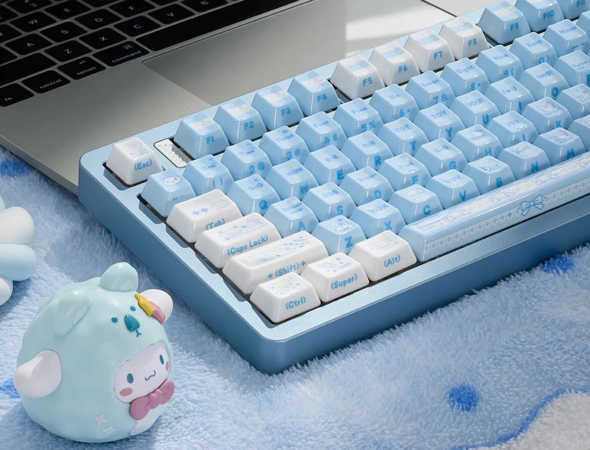 A collection of lustrous premium ceramic Cinnamoroll keycaps shown from various angles, highlighting the whimsical side-engraved art and soft vibrant color.