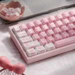 A collection of artisanal My Melody ceramic keycaps, showcasing their smooth texture and adorable pastel designs from various charming angles.