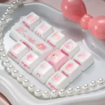 A delightful close-up of artisanal My Melody ceramic keycaps, showcasing their smooth texture, whimsical pastel hues, and adorable character designs.