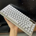 An elegant side view of the silver Feather keycaps, revealing their luminous side-engraved details and the sophisticated metallic sheen.