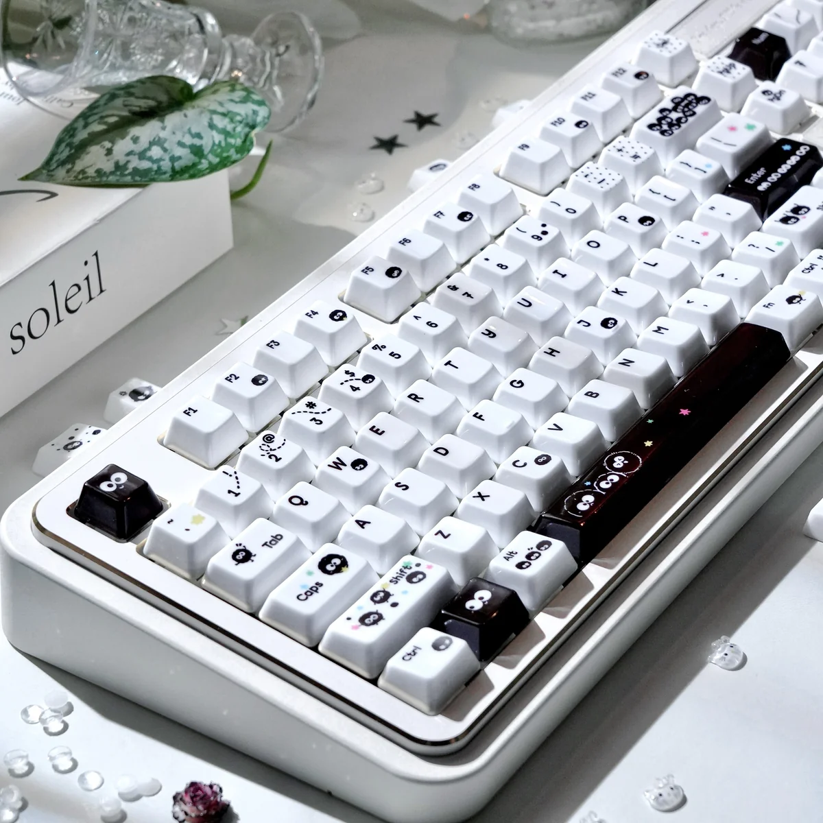 Artistic handcrafted Susuwatari keycap from Ghibli, featuring its whimsical black and white design and unique artisan texture in a detailed.