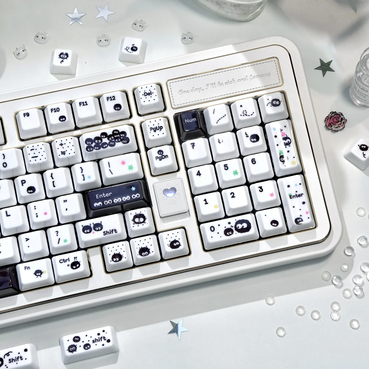 Close-up of a handcrafted Susuwatari keycap, revealing its whimsical Ghibli design and unique black and white texture from an artistic.