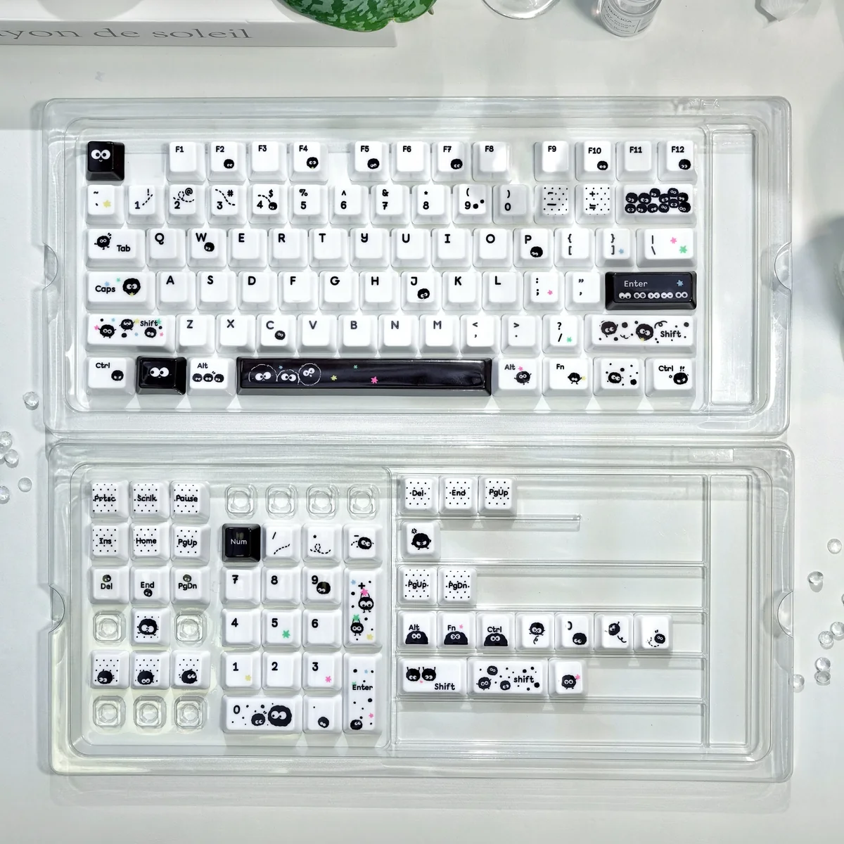 Close-up of a whimsical, handcrafted black and white Susuwatari keycap, showcasing its unique artisan finish and Ghibli nostalgia.