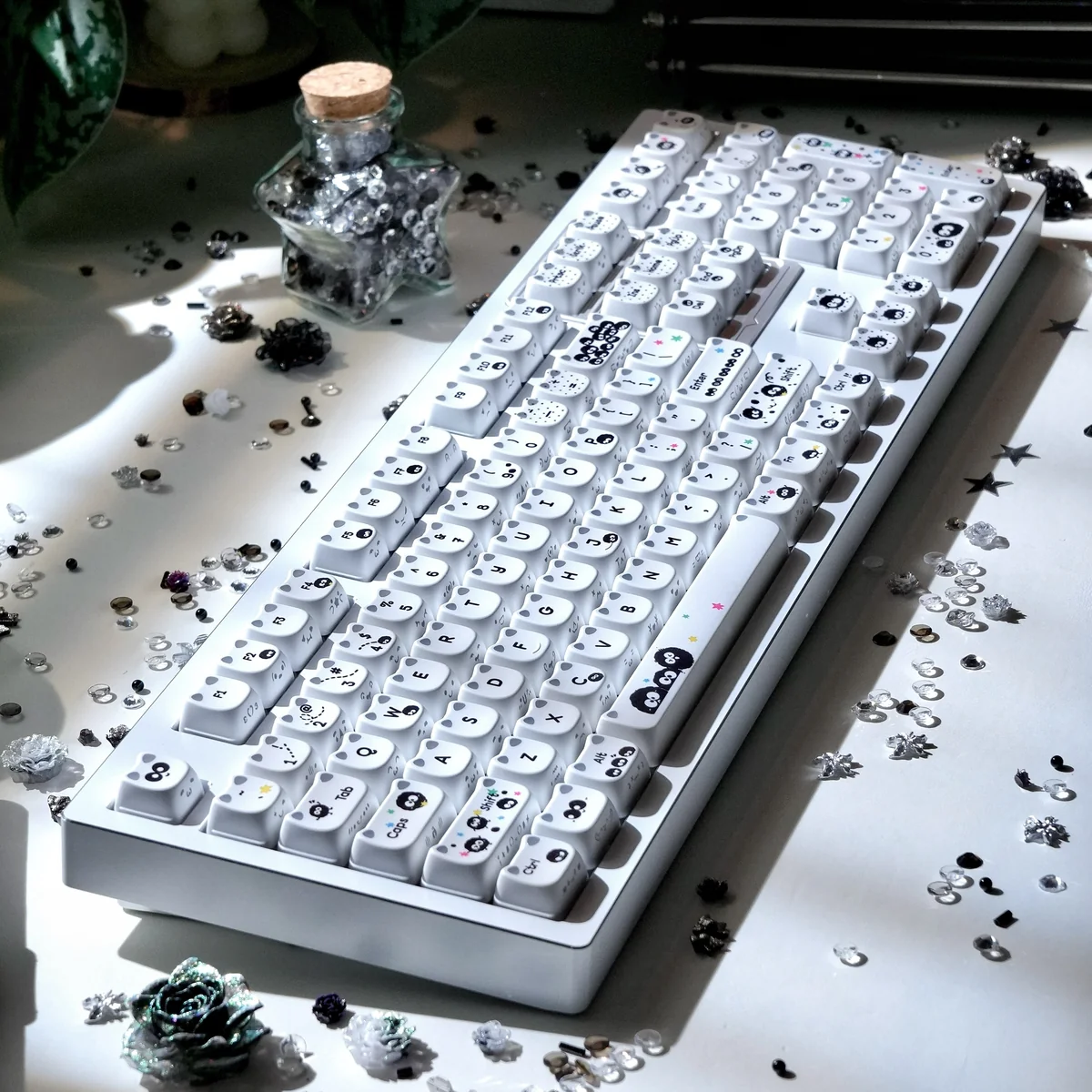Handcrafted artisan Susuwatari keycap, showcasing a whimsical MAO expression delicately side-engraved.
