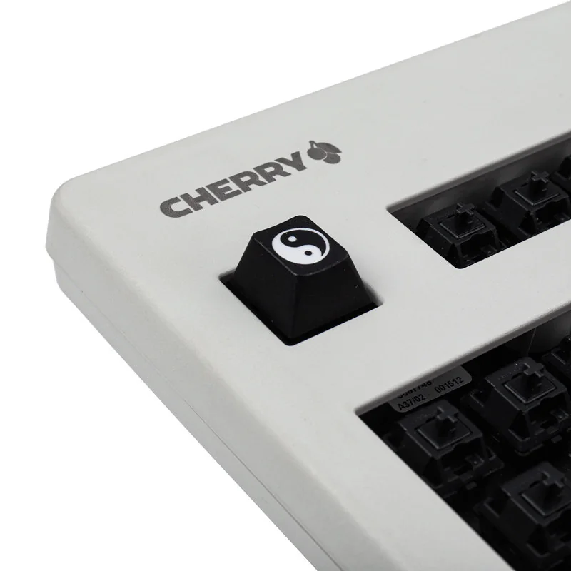 Deep laser-engraved Taiji PBT keycap. Harmonious Yin Yang artisan design from multiple angles highlights its timeless elegance and durable PBT material.