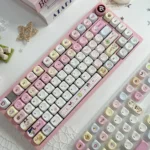 Nostalgic Tamagotchi PBT dye-sub keycaps set. Vibrant, pixelated retro-tech characters displayed from multiple angles, highlighting playful designs.