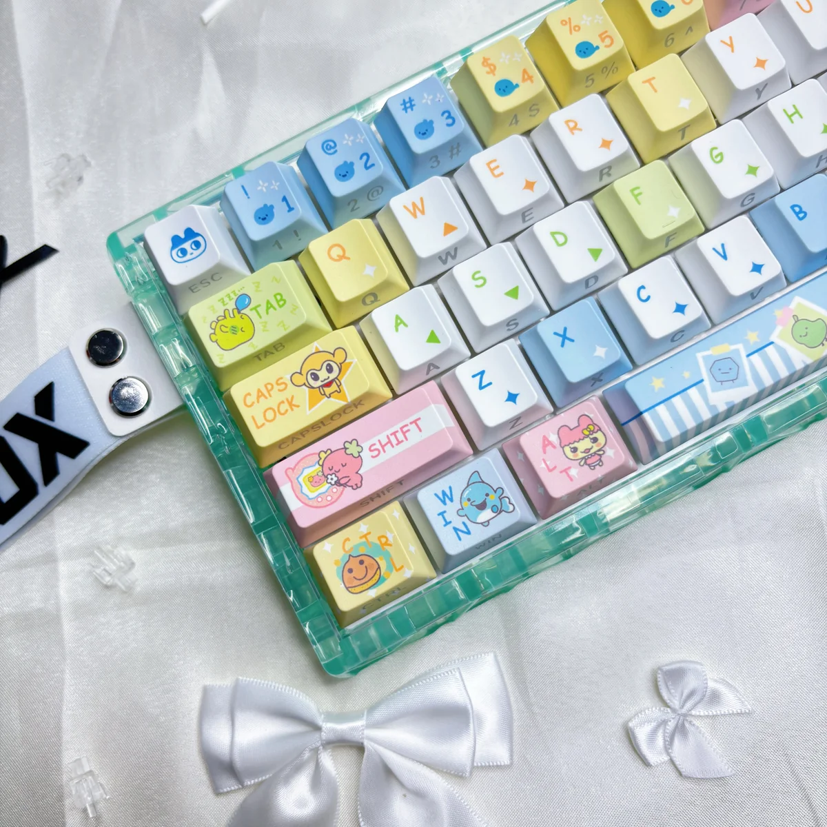 Vibrant Tamagotchi Keycaps PBT set, showcasing pixelated retro digital pet designs from multiple angles. This exclusive collection brings a nostalgic keyboard..