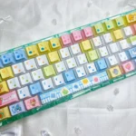 Tamagotchi PBT keycaps set from various angles. Vibrant, pixelated retro digital pet designs provide an exclusive, nostalgic, playful keyboard aesthetic.