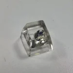 Multiple views of the Delta Force Heart of Africa handcrafted resin keycap, revealing its unique translucent epoxy design with deep black and pure white design.