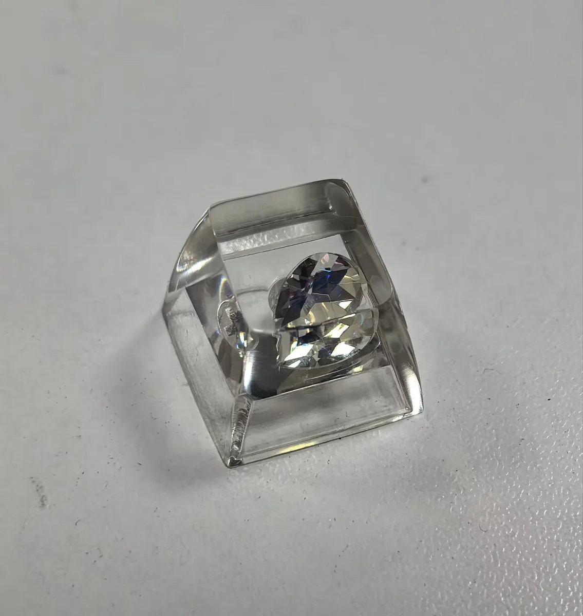 Multiple views of the Delta Force Heart of Africa handcrafted resin keycap, revealing its unique translucent epoxy design with deep black and pure white design.