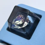 Close-up of the black Delta Force Heart of Africa handcrafted resin keycap, uniquely designed with deep black translucent epoxy resin and intricate white design.