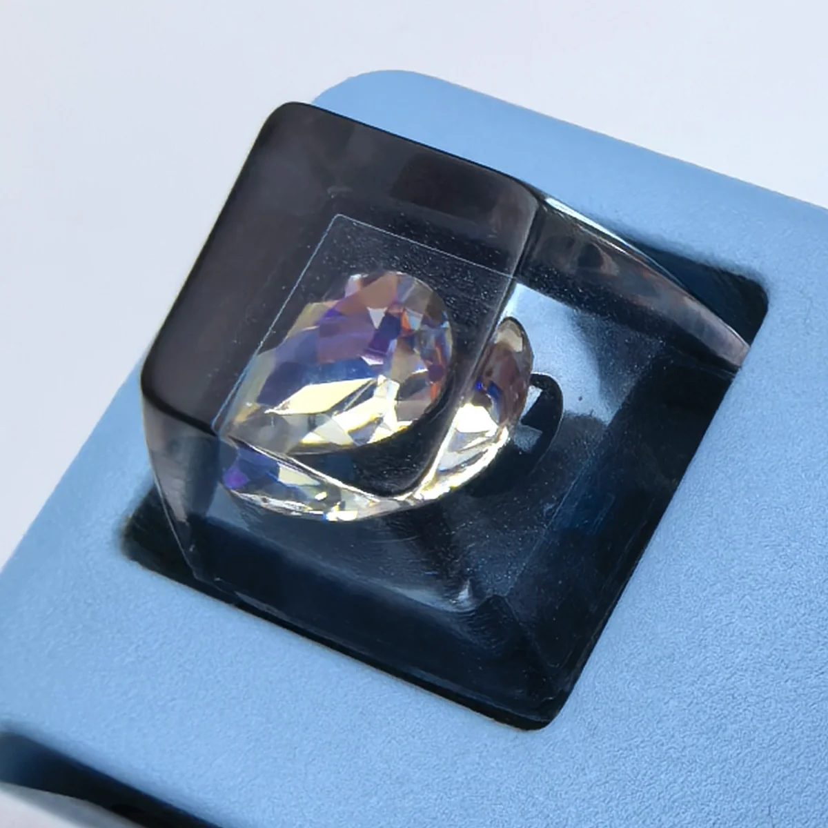 Close-up of the black Delta Force Heart of Africa handcrafted resin keycap, uniquely designed with deep black translucent epoxy resin and intricate white design.