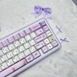 Official Violet Evergarden PBT keycaps set, featuring elegant violet and blue typewriter motifs from multiple artistic angles.