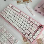 A delightful collection of Whimsical Wishing Bottle Pink MOA Keycaps, viewed from various angles, highlights their enchanting pink hues and adorable.