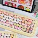 Delightful close-up of exclusive Yumeiro Patissiere PBT keycaps, revealing intricate pastel dessert art and adorable anime characters for a sweet keycap/