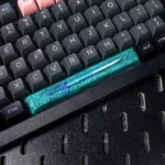 Close-up of a premium Zelda keycap, showcasing the iconic Hylian Shield and Master Sword design with intricate detail from multiple angles.
