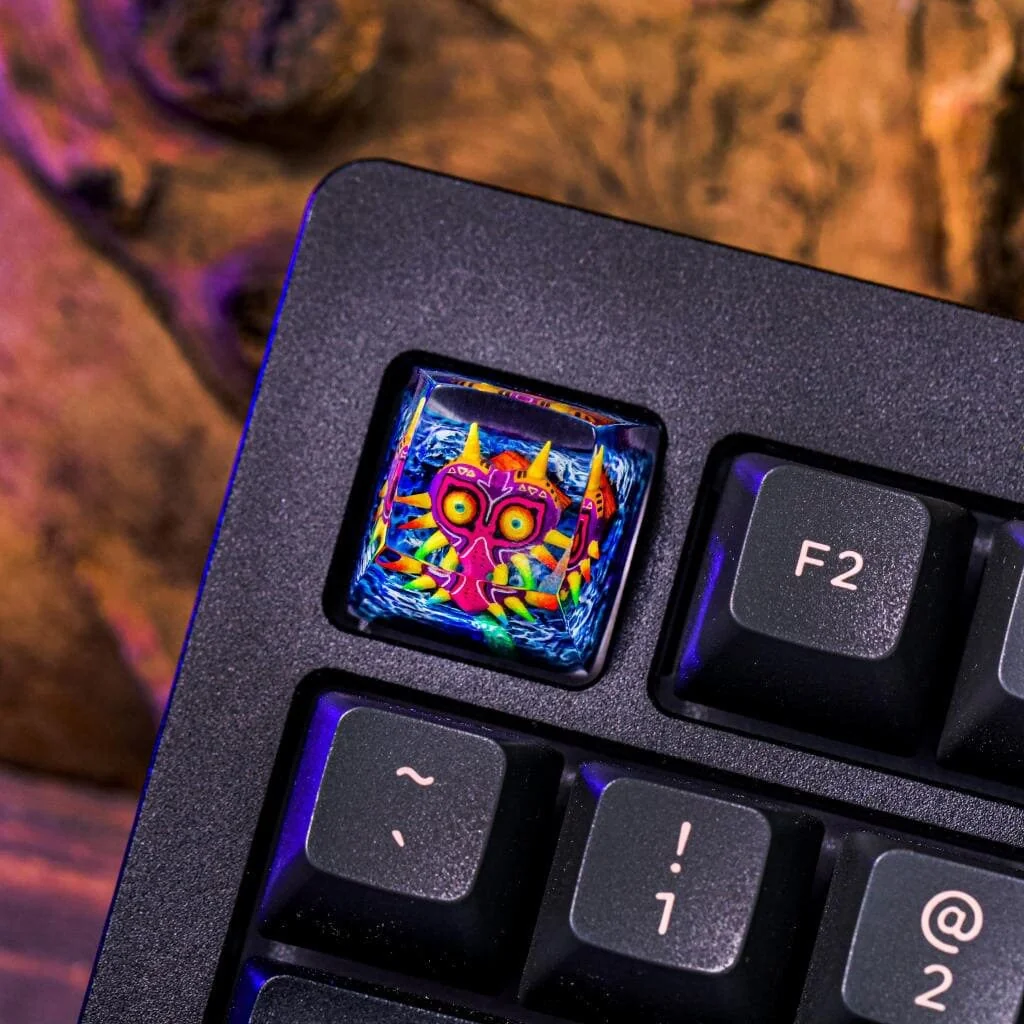 Exquisite handcrafted The Legend of Zelda: Majora's Mask Transparent Keycap featuring an intricate backlit Majora's Mask artisan sculpture, a premium collectible.